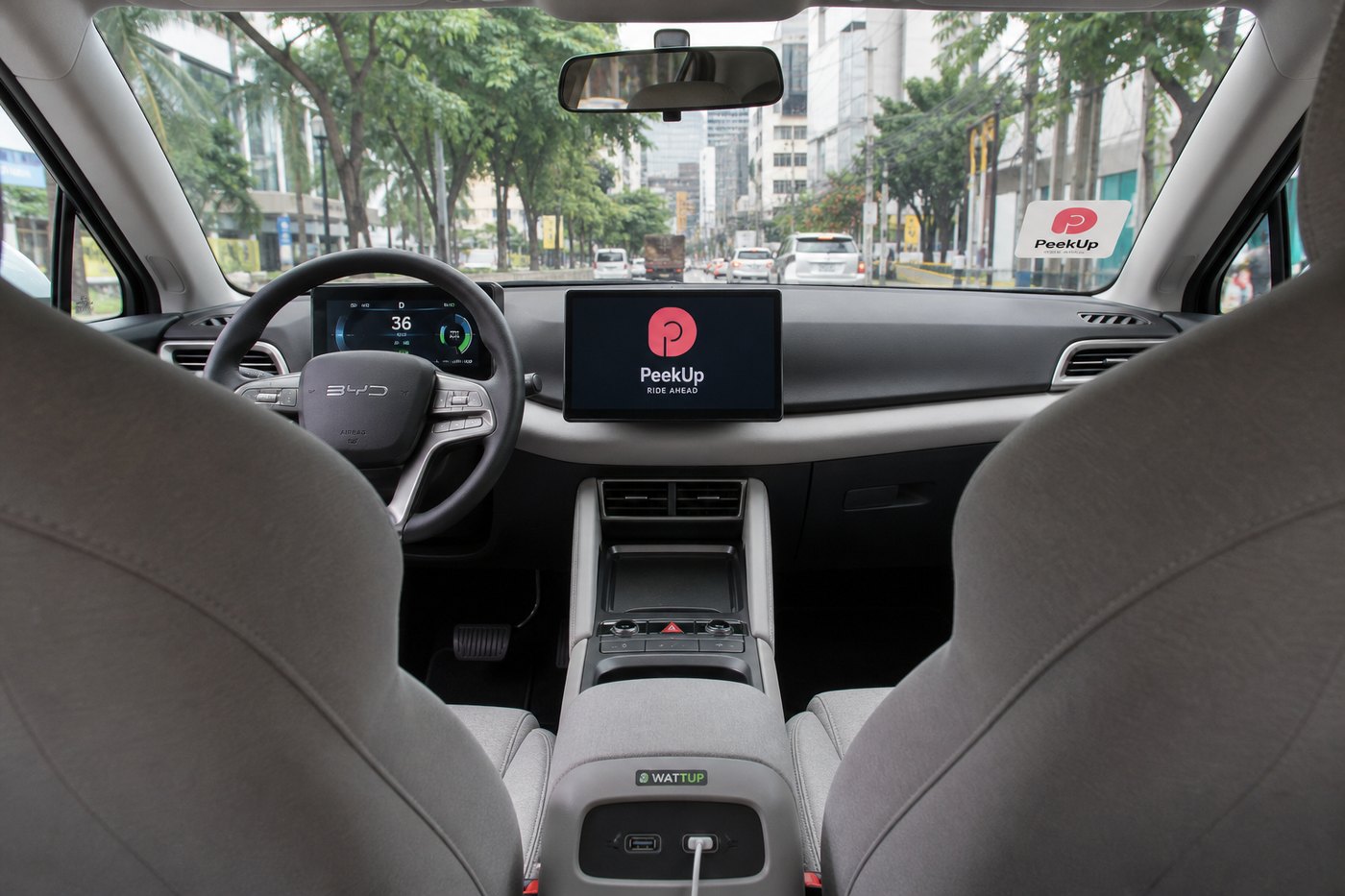 Passenger-view interior of a modern electric vehicle with digital dashboard, central screen, and visible USB ports.